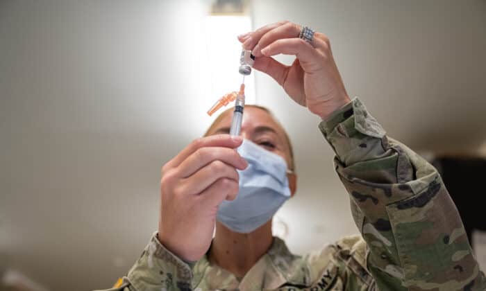 FORT KNOX, KY - SEPTEMBER 09: A Preventative Medicine Services technician fills a syringe with a Janssen COVID-19 vaccine on September 9, 2021 in Fort Knox, Kentucky. The Pentagon, with the support of military leaders and U.S. President Joe Biden, mandated COVID-19 vaccination for all military service members in early September. The Pentagon stresses inoculation from COVID-19 and other diseases to avoid outbreaks from impeding the fighting force of the US Military. (Photo by Jon Cherry/Getty Images)